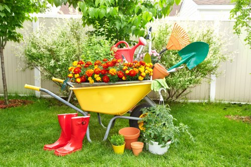 Gardener pruning shrubs in Dalston garden